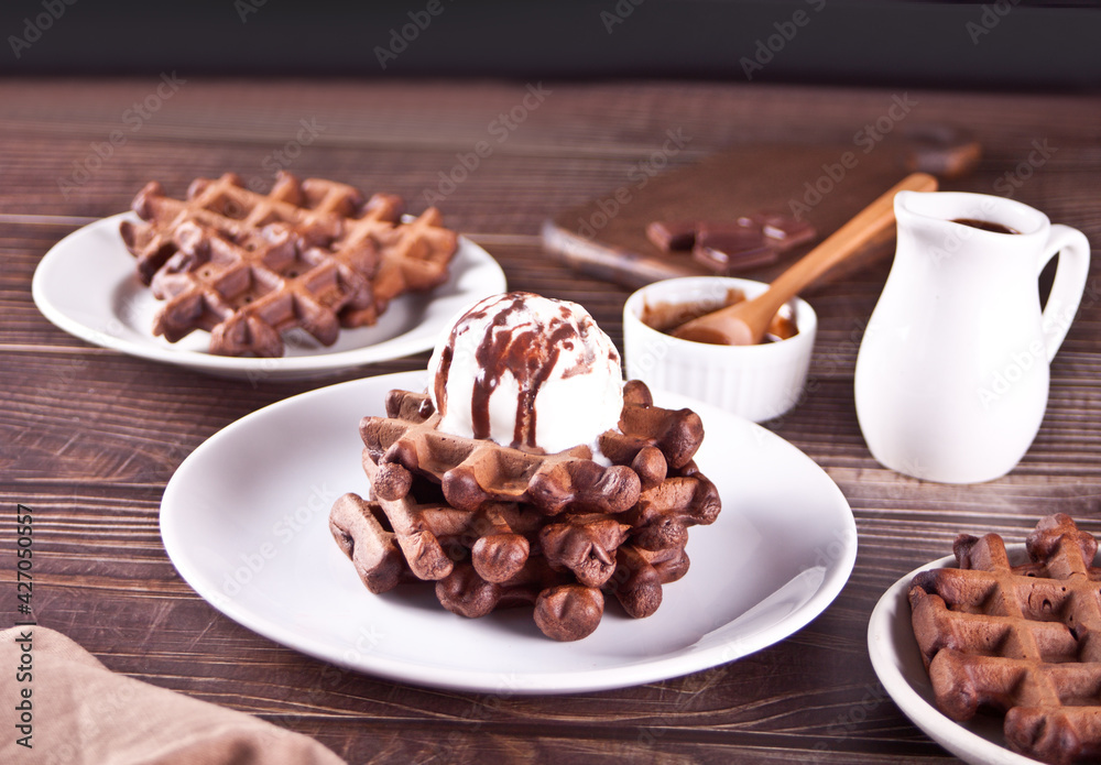 Fototapeta premium Homemade chocolate waffles with ice cream decorated chocolate syrup.