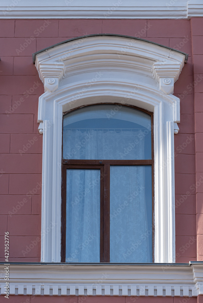 Fototapeta premium Windows on old city facades, with decorative elements