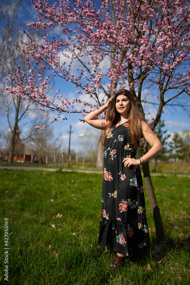 Young woman with cherry trees in bloom