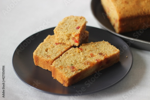Slices of tutti frutti cake loaf made with whole wheat flour.