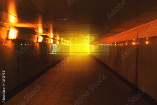 Underground passage with lanterns. Pedestrian crossing in the city. Long empty tunnel with light