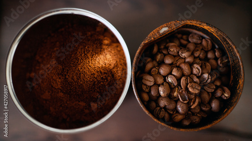 coffee beans and ground coffee are in cans on the table. copy space. Banner for a caffeinated drink.