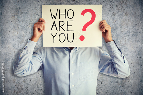 Bild auf Leinwand Who are you question about character with businessman holding board