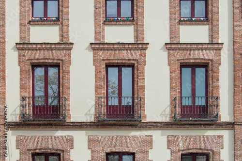 three independent balconies with brick lintel and iron railing