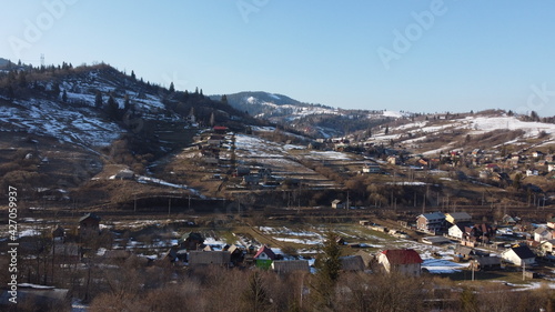 Drone shot. View of the village at the foot of the mountains. Carpathians. Ukraine.