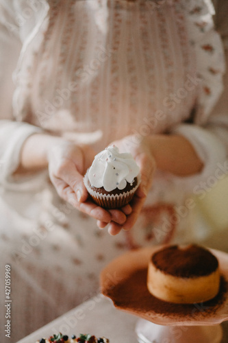 confectioner makes sweet delicious cakes at home. in bright colors