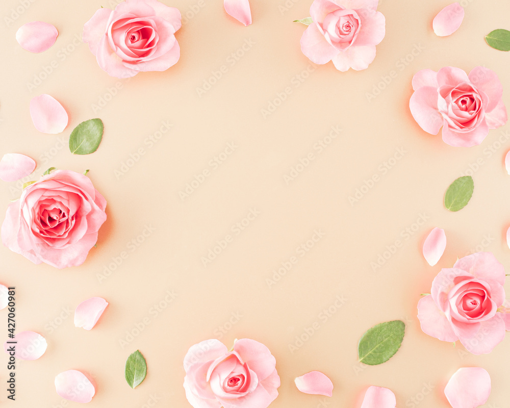 Pink rose, petals, leaves arranged on a golden background and a message space in the middle