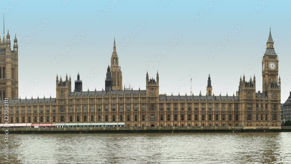 Houses of Parliament at coast of Thames river with Big Ben Tower and Westminster Bridge in London during sunny summer day Houses of Parliament at coast of Thames river with Big Ben Tower and Westminster Bridge in London during sunny summer day