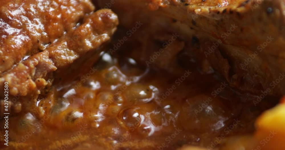 Bacon with potatoes simmering in thick sauce, close up, no people Bacon with potatoes simmering in thick sauce, close up, no people