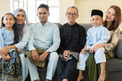 Eid Mubarak celebration moment, family wearing traditional cloth smiling photo