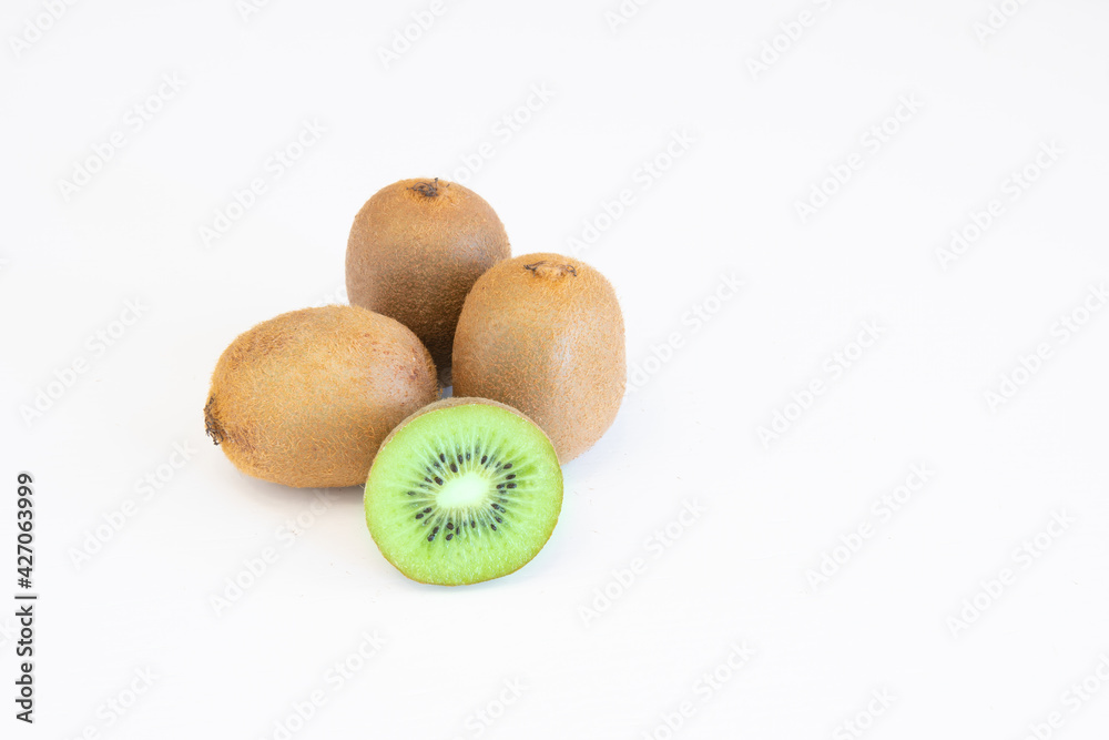 Whole and halves kiwi fruits isolated on white background with text space Whole and halves kiwi fruits isolated on white background with text space