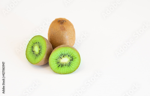 Whole and halves kiwi fruits isolated on white background with text space