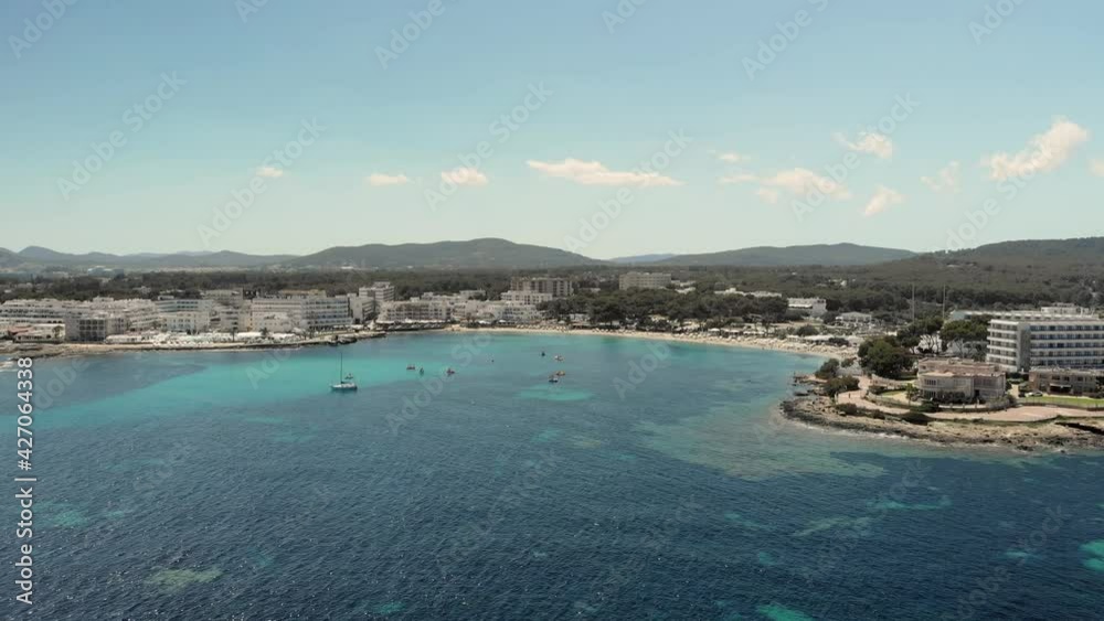 Aerial view of the bay os Es Canar village of Ibiza Island. Boats at the bay, sailling on turquoise water. Aerial view of the bay os Es Canar village of Ibiza Island. Boats at the bay, sailling on turquoise water.