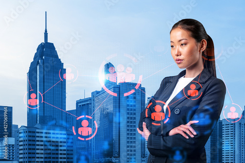 Photography Attractive young Asian HR director at international company is thinking about recruitment of highly qualified specialists