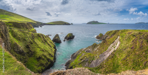 Beautiful panorama of tall cliffs, turquoise water and islands at Dunquin Pier or harbour, Dingle, Wild Atlantic Way, Kerry, Ireland photo