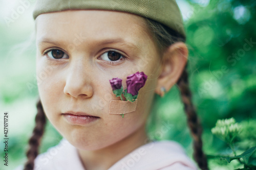 Wallpaper Mural Little caucasian girl portrait with flowers on cheek and military hat Torontodigital.ca