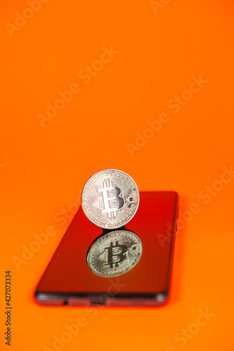 Photograph of bitcoin coins symbolizing the financial market of cryptocurrencies on a colored background and without people