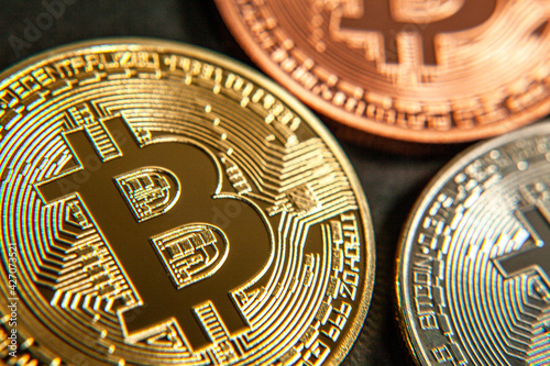Photograph of bitcoin coins symbolizing the financial market of cryptocurrencies on a colored background and without people