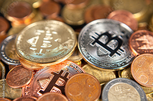 Photograph of bitcoin coins symbolizing the financial market of cryptocurrencies on a colored background and without people