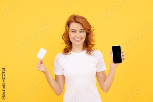 Quadro em tela happy woman showing credit or debit card and smartphone to make online shopping, online banking