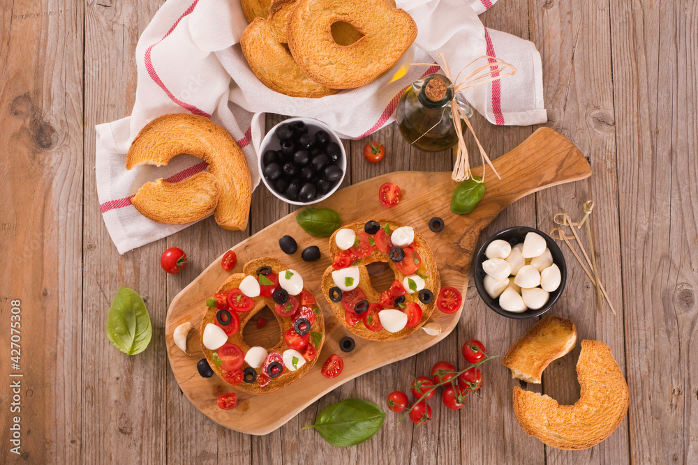 Friselle with tomatoes and mozzarella cheese. Friselle with tomatoes and mozzarella cheese.