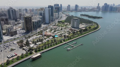 Sharjah: Aerial view of Sharjah city and Khalid lake, Al Noor Mosque, modern skyscrapers in the United Arab Emirates. 4k photo