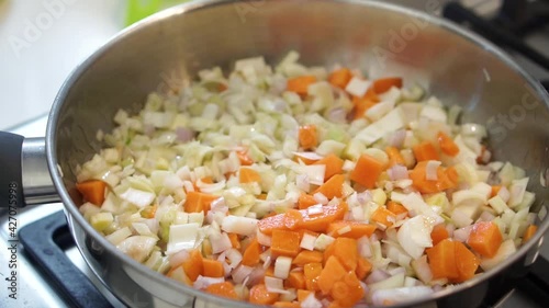 Frying off mirepoix ingredients in pan photo