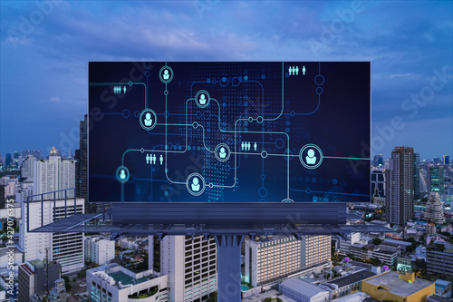 Glowing Social media icons on billboard over night panoramic city view of Bangkok. The concept of networking and establishing new connections between people and businesses in Southeast Asia