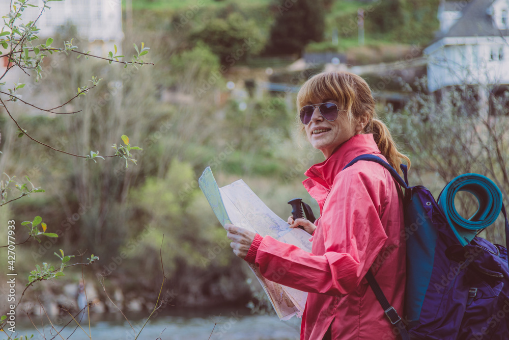 woman with hiking map with backpack in nature woman with hiking map with backpack in nature