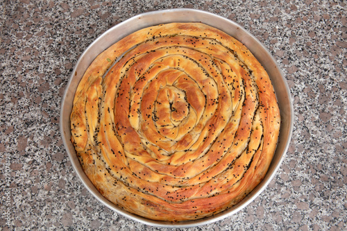 Bosnian borek. Homemade rolled borek, spinach, potato and feta cheese, turkish cuisine. Turkish Culture Ramadan and Eid-Adha holiday catering preparation. photo