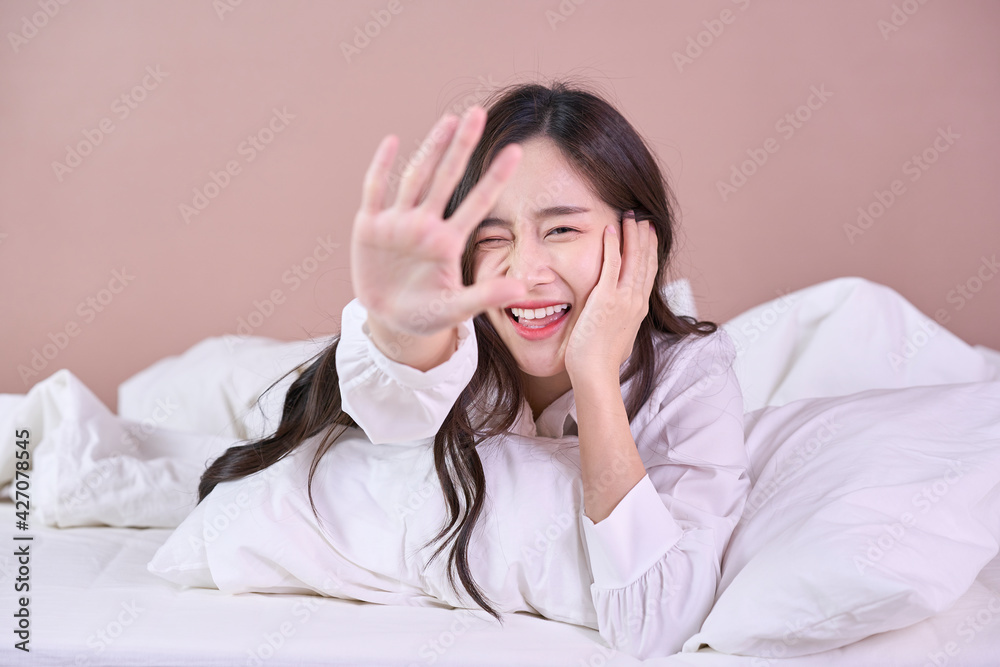 Funny and joyful Asian woman smile on bed. Close up cute girl Funny and joyful Asian woman smile on bed. Close up cute girl