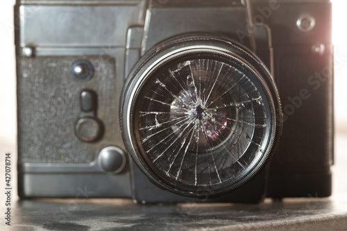 broken lens on the old vintage film camera, selective focus