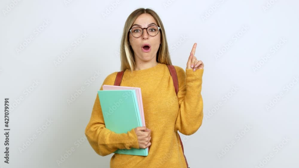 Young woman with backpack standing and thinking an idea pointing the finger up over isolated background Young woman with backpack standing and thinking an idea pointing the finger up over isolated background