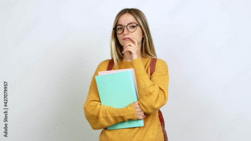 Young woman with backpack having doubts and questioning an idea over isolated background Young woman with backpack having doubts and questioning an idea over isolated background