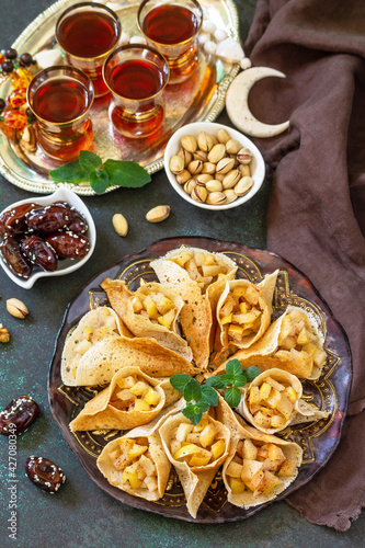 Arabic Cuisine. Ramadan Kareem Festive. Ramadan menu, arabian pancake katayef (katayev, qatayef) with apple filling and cinnamon.