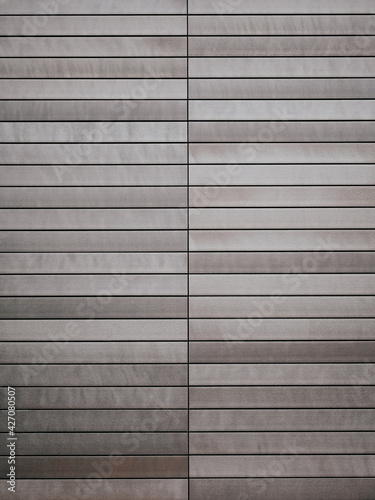 Abstract looking building exterior with metal planks in different shades of brown and gray