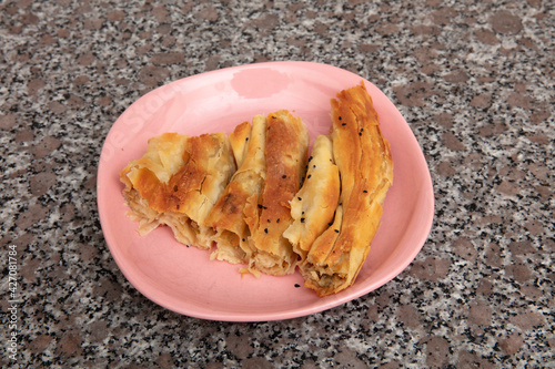 Bosnian borek. Homemade rolled borek, spinach, potato and feta cheese, turkish cuisine. Turkish Culture Ramadan and Eid-Adha holiday catering preparation. photo