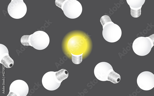 The concept of big idea, creativity and inspiration. Luminous light bulb on a dark background with other off bulbs.