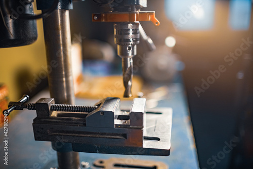 Drilling machine at the workplace of a toolman locksmith photo