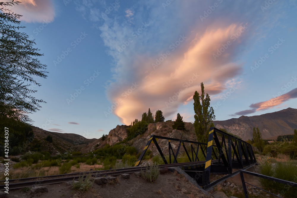 Scene view of an iron railway bridge against mountains during sunset in Esquel, Patagonia, Argentina