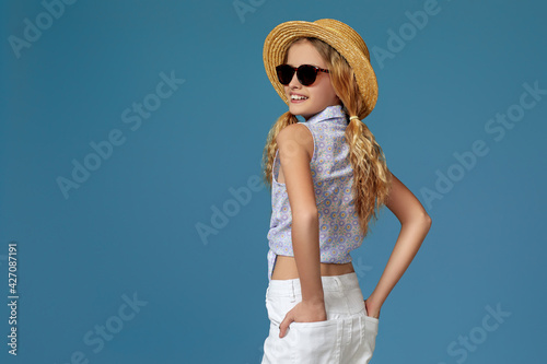 beautiful little girl in summer hat and sunglasses
