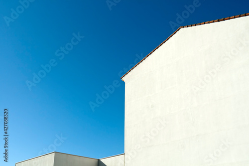 White wall silhouettes in front of blue sky