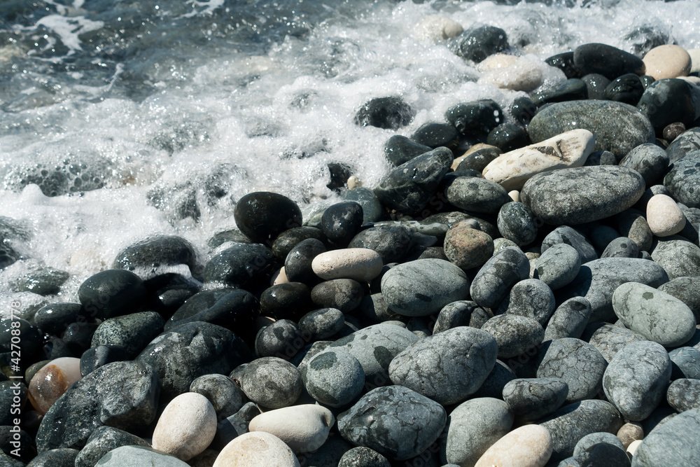 Wet and dry stones on the beach Wet and dry stones on the beach