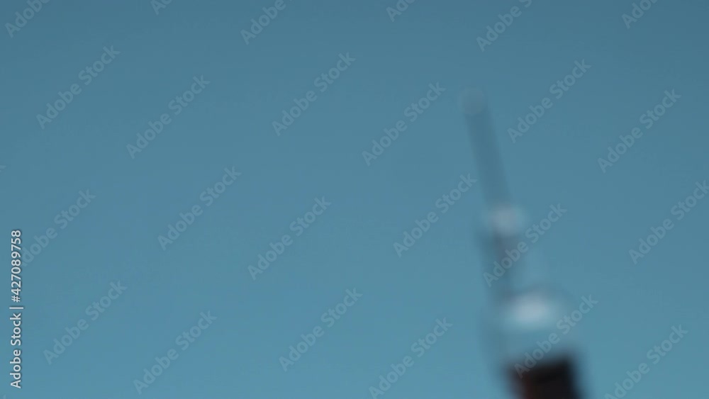 a syringe with medical supplies (vaccine) on blue background a syringe with medical supplies (vaccine) on blue background