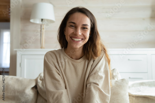 Screen view of happy millennial Hispanic woman look at camera have webcam online digital conference. Portrait of smiling young female speak talk on video call at home. Virtual event concept. photo