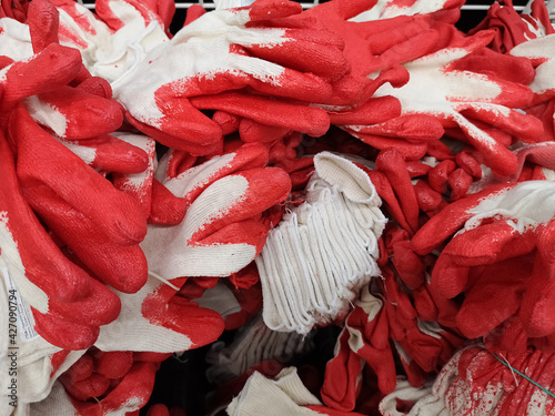 Box with rubberized gloves for gardening in a large building store photo