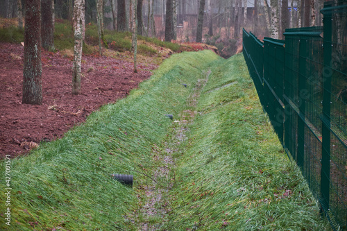 Photography Irrigation drainage channel in the wild forest park on the hillside, rain storm ditch on the outskirts of the city