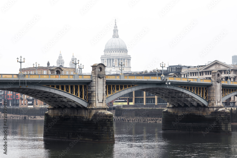 City of London and St. Pauls cathedral in raining, misty day view from the River Thames. Empty streets of London during national lockdown UK, 2021