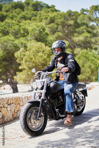 Biker on motorbike in nature. Freedom concept