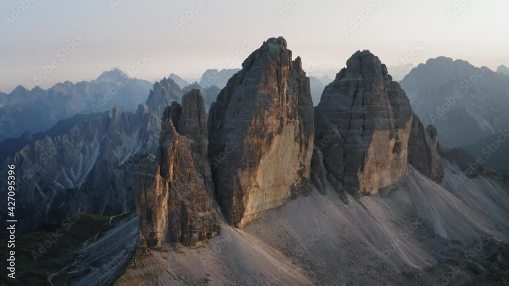 Drone aerial footage of Tre Cime di Lavaredo most visited mountain in Sexten Dolomites Alps in Italy at sunset. Nature alpine park with epic landscape in South Tirol, Europe